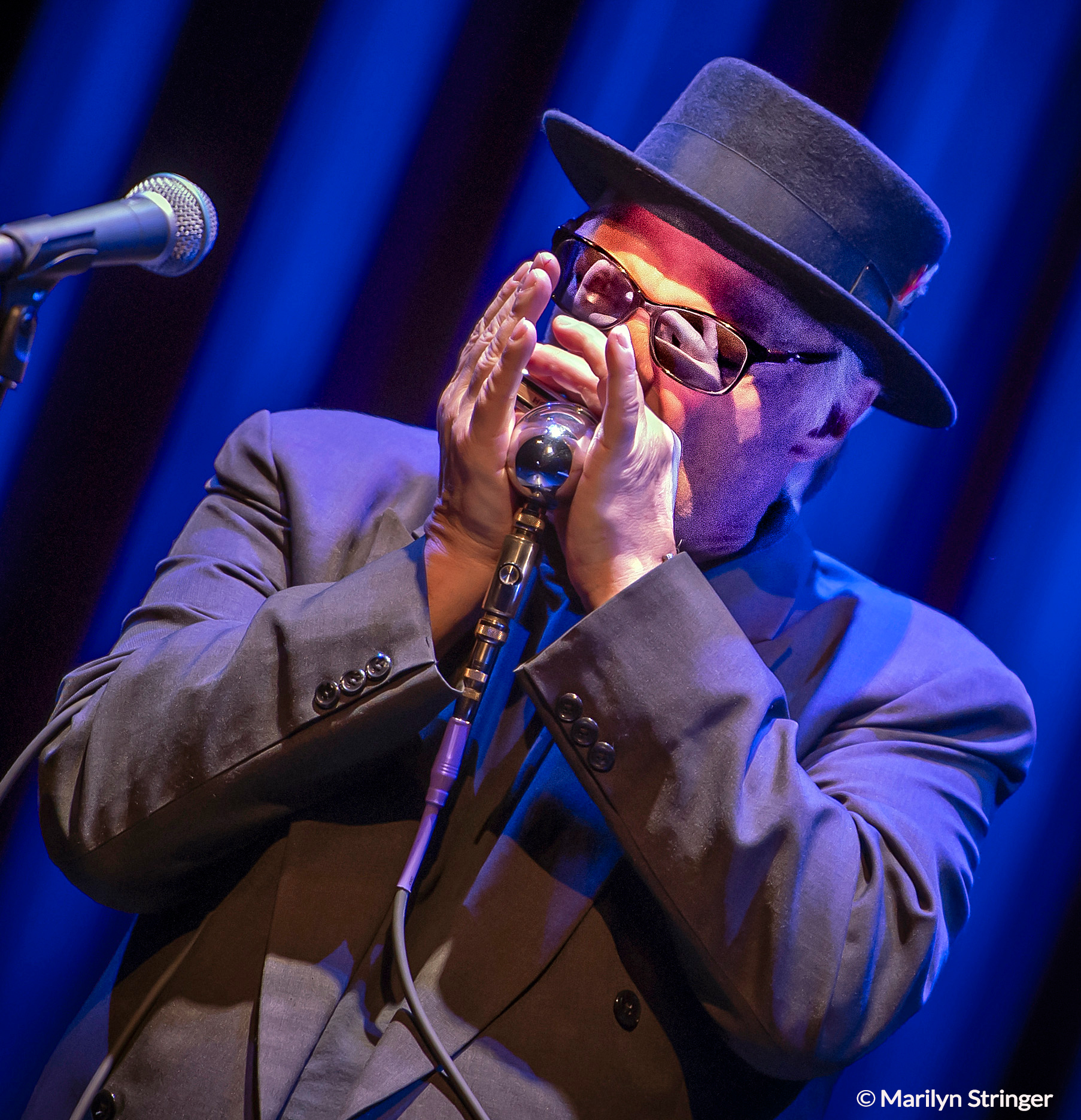 Curtis Salgado on stage playing harmonica
